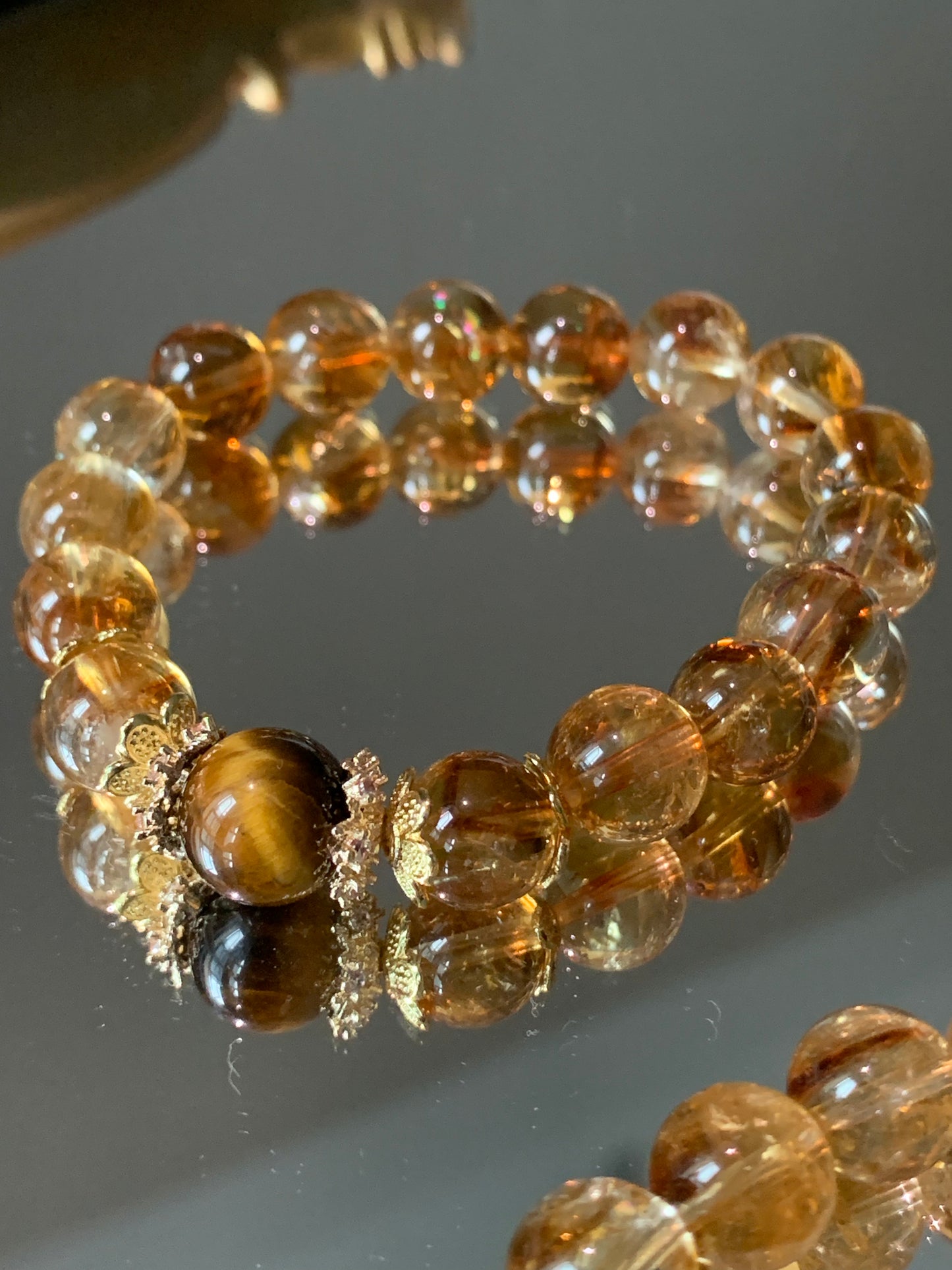 Citrine gemstone bracelet promoting abundance and prosperity, adorned with beautiful silver-plated floral accents.