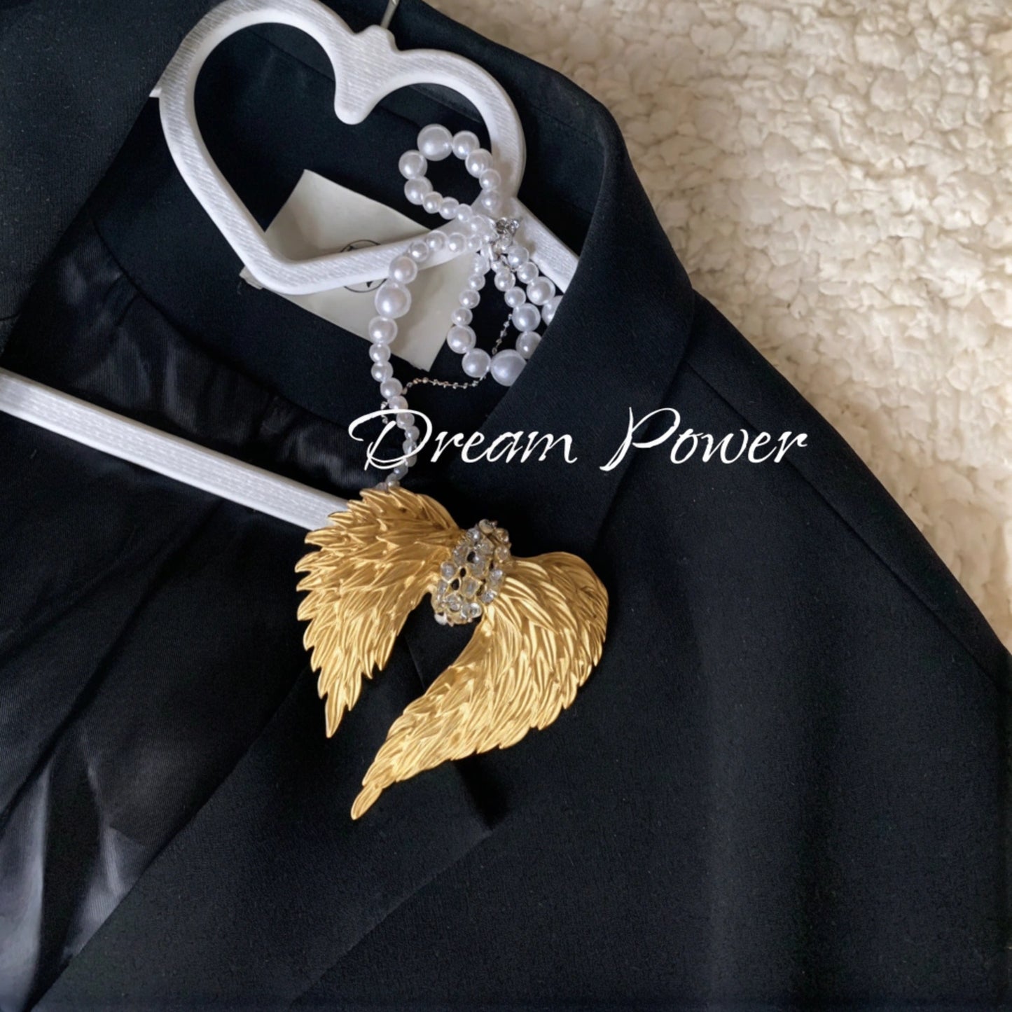 perfect brooch pinned on a black blazer hanging on a heart-shaped cloth hanger, for the ones when chasing dream.