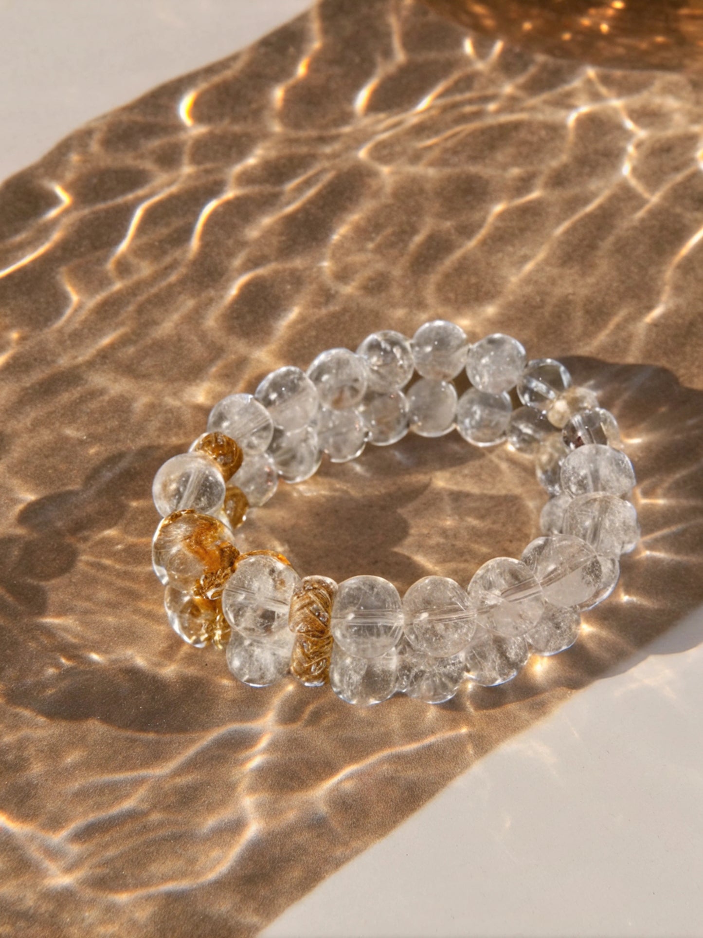 Healing energy of the Renewal Power Rock Crystal Bracelet with silver-gold accents and natural white agate beads.