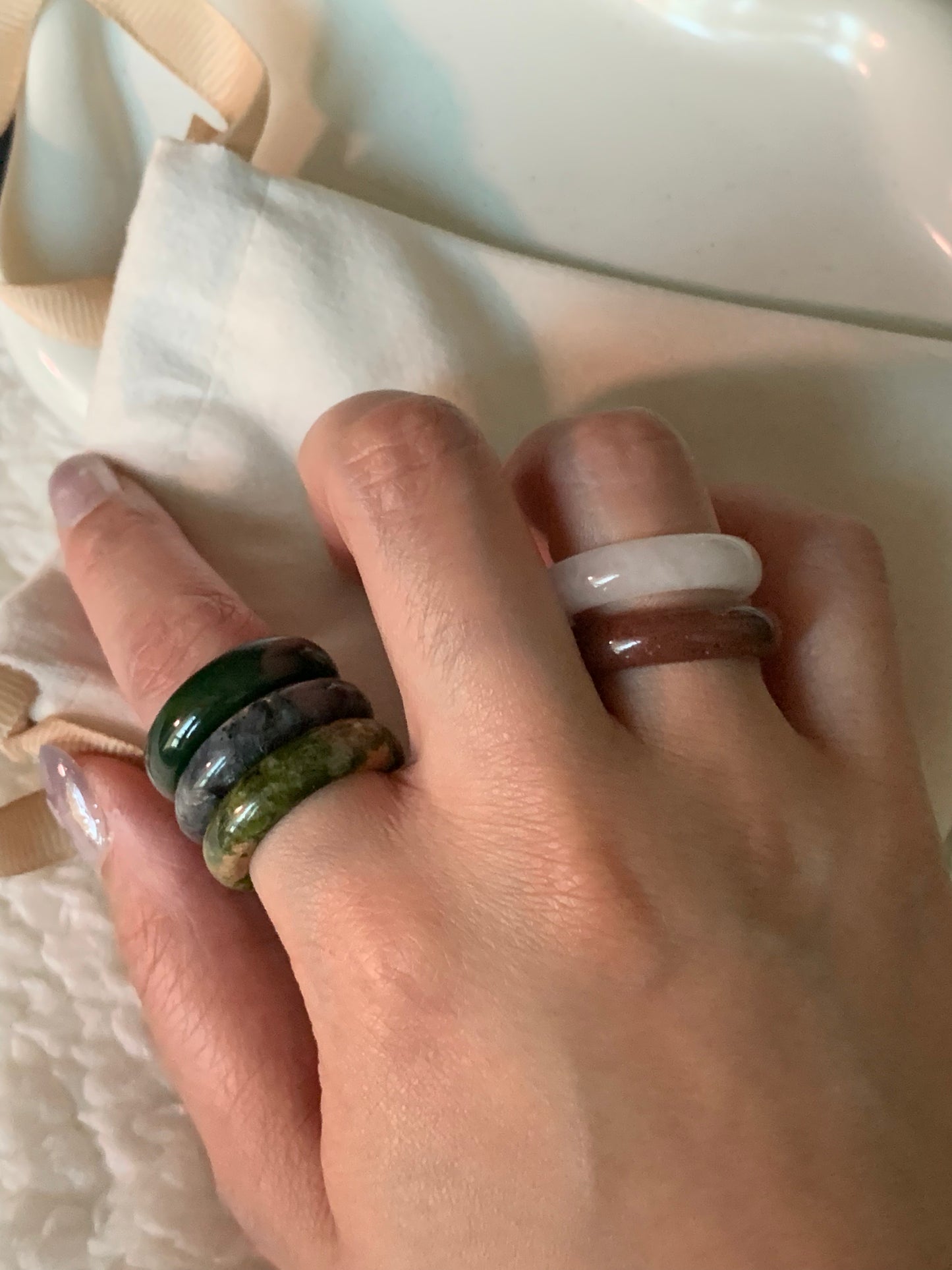 An elegant arrangement of multiple rings layered together, highlighting their unique designs and color combinations.