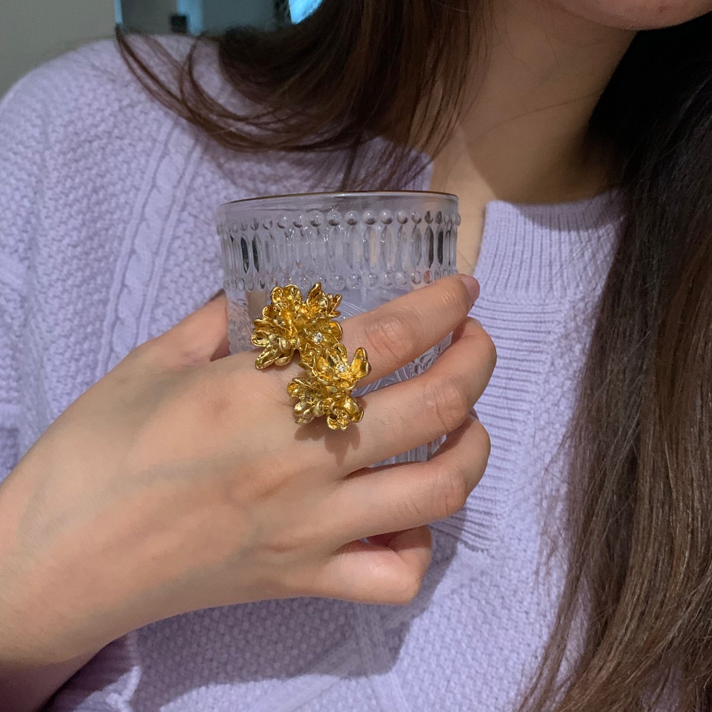 Lifestyle shot of a model wearing the twin blossom ring at an outdoor event