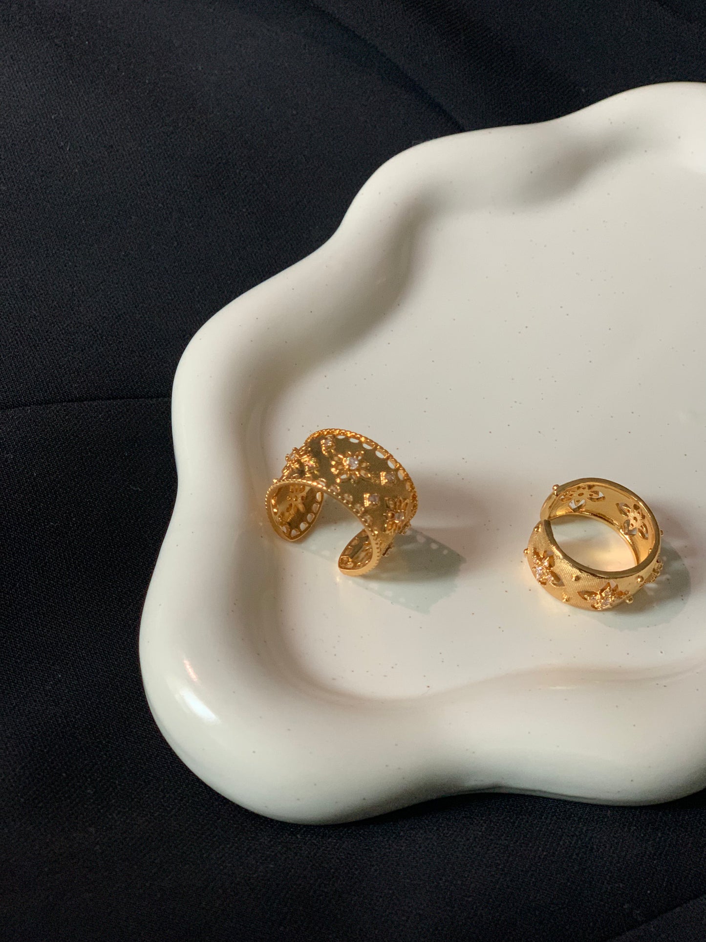 Close-up of vintage gold ring with intricate detailing and 18K gold finish.