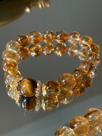 Citrine gemstone bracelet promoting abundance and prosperity, adorned with beautiful silver-plated floral accents.