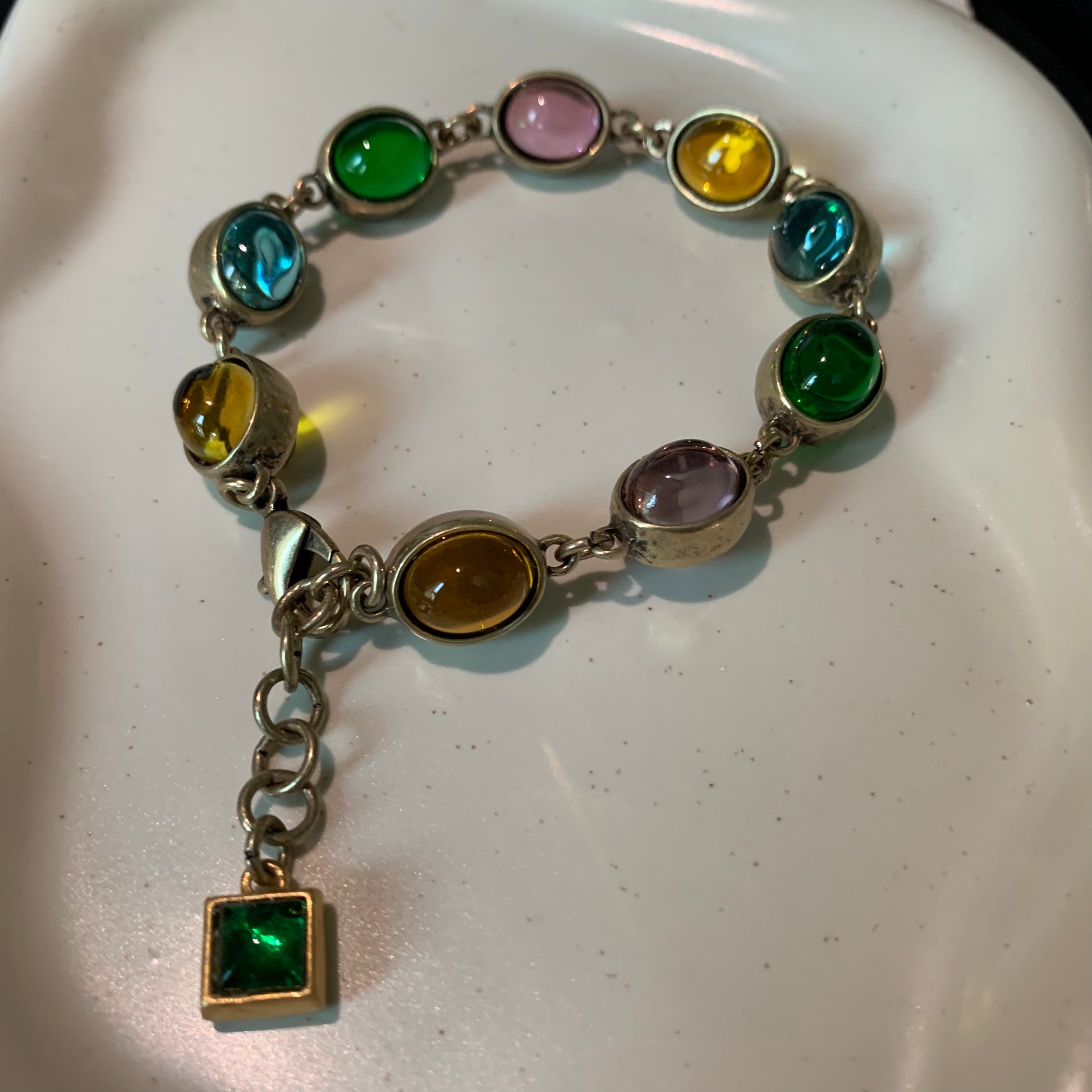 Close-up of the rainbow friendship bracelet with various gemstones