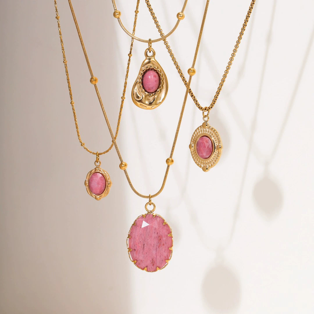 Elegant display of different rhodochrosite necklaces hanging under sunshine