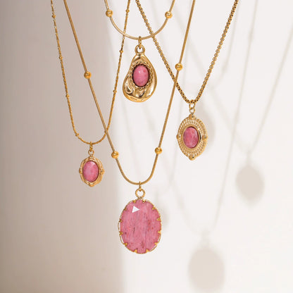 Elegant display of different rhodochrosite necklaces hanging under sunshine