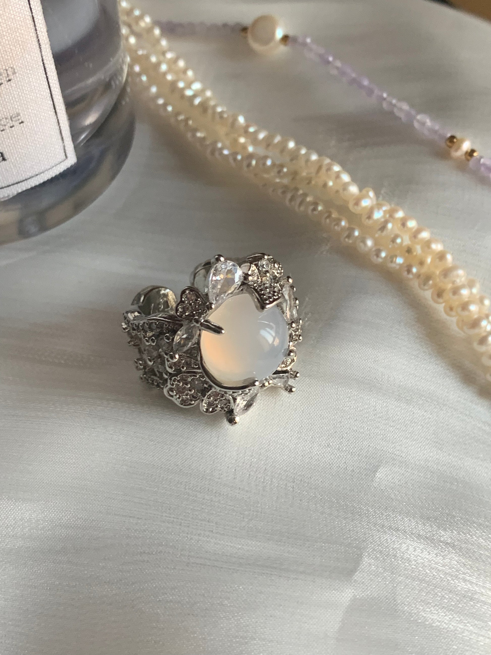 Elegant white jade ring displayed on a soft fabric background, representing inner peace.