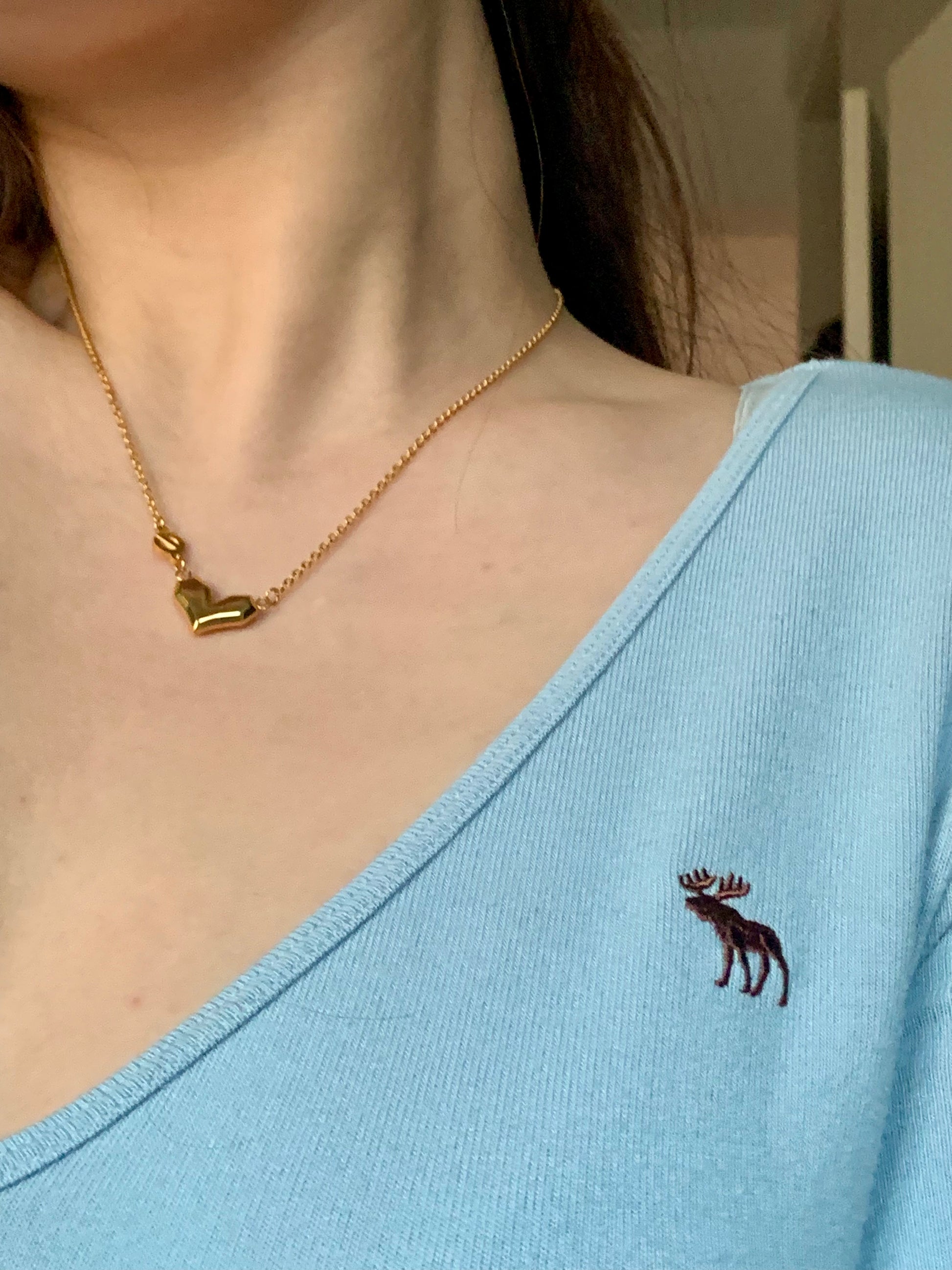 Elegant Love Power Heart Gold Necklace displayed on a girl's neck, ideal for modern women
