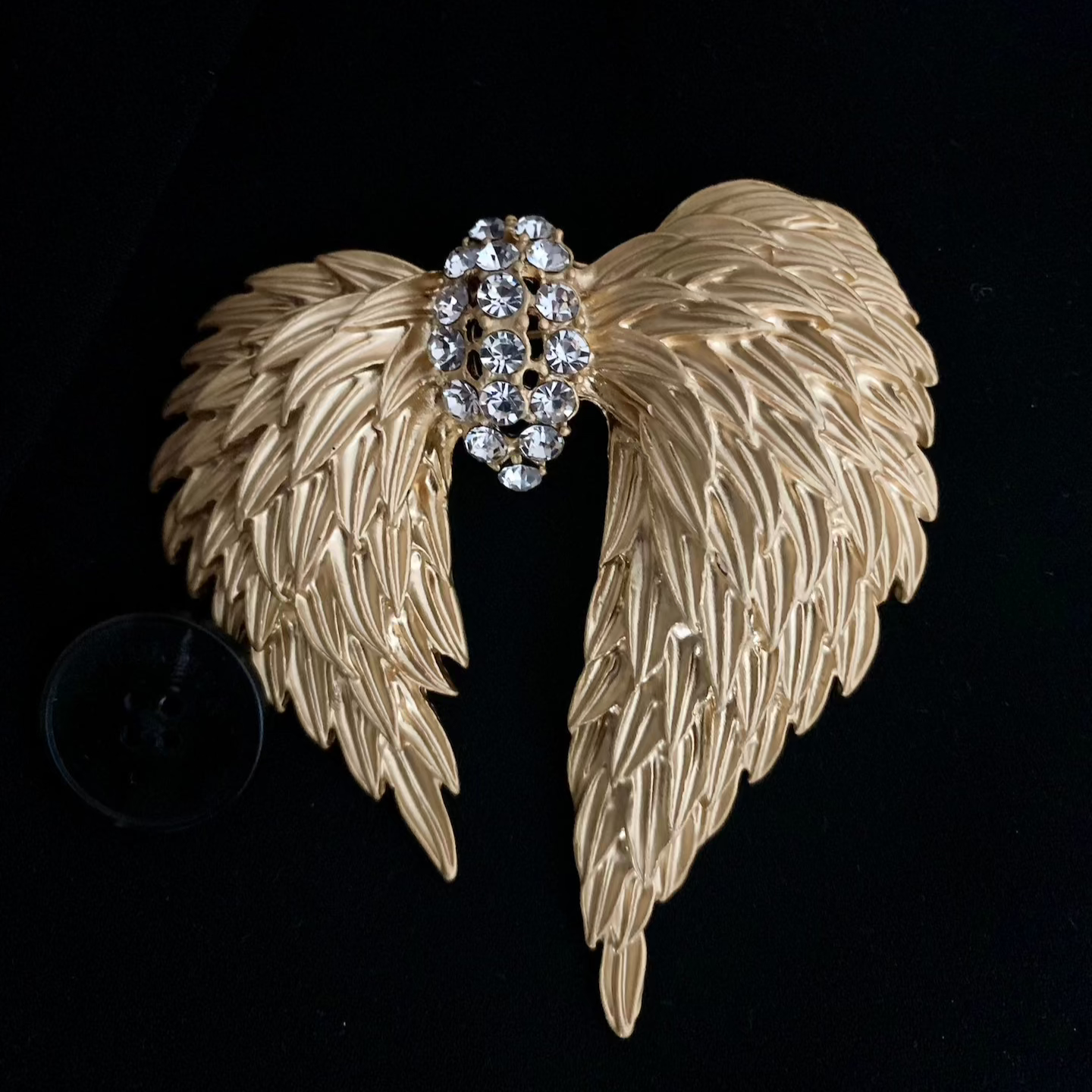Close-up of the Dream Wings Brooch showcasing gold plating copper texture and details