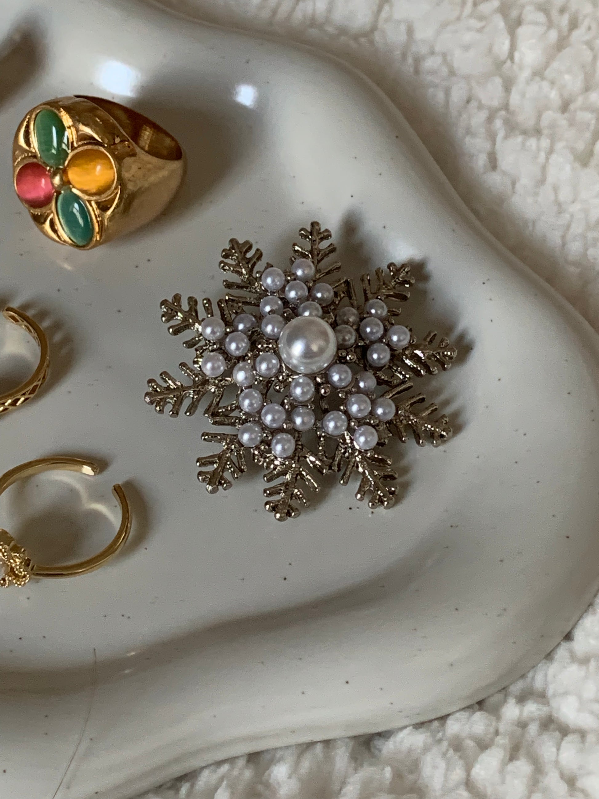 Close-up detail of the Joy Power Pearl Snowflake Brooch highlighting the shimmering pearls and sparkling embellishments.