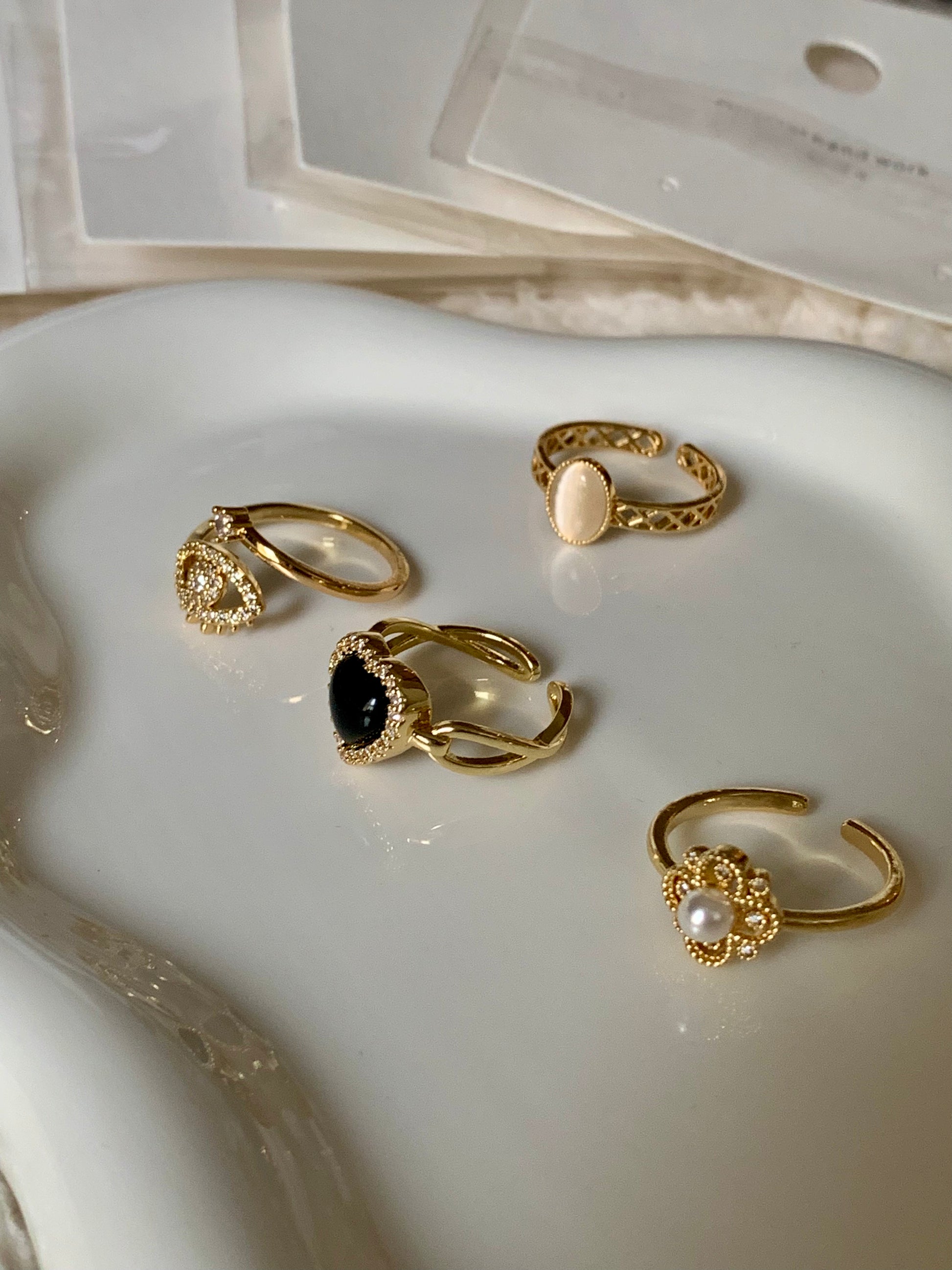Display of the Love Power jewelry collection, featuring the Obsidian Heart Gold Ring alongside complementary pieces, beautifully arranged to highlight their elegance and exquisite craftsmanship.