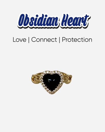 Love Power Obsidian Heart Gold Ring featuring a heart-shaped obsidian stone surrounded by sparkling zirconia, set in an 18k gold plated band. Perfect for expressing love and strength.