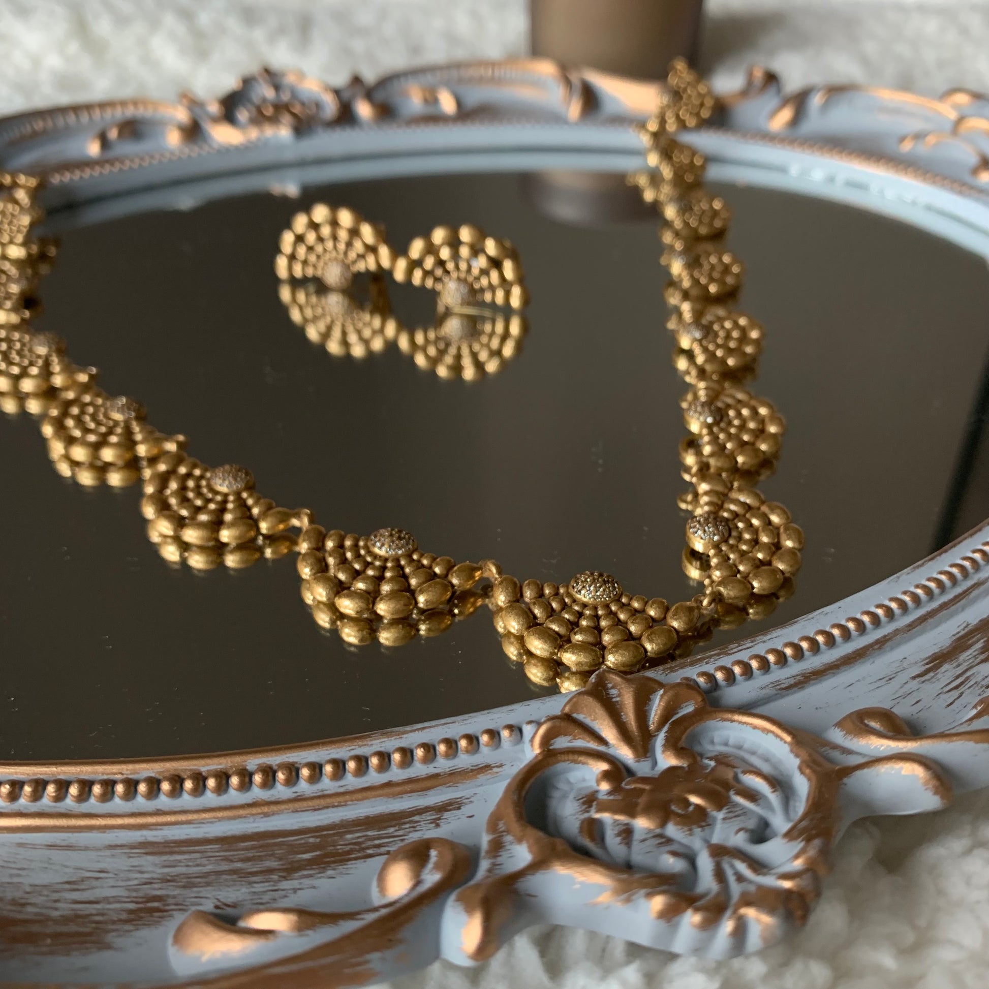 Close-up of the Spiritual Power gold jewelry set showcasing its intricate retro patterns and design.