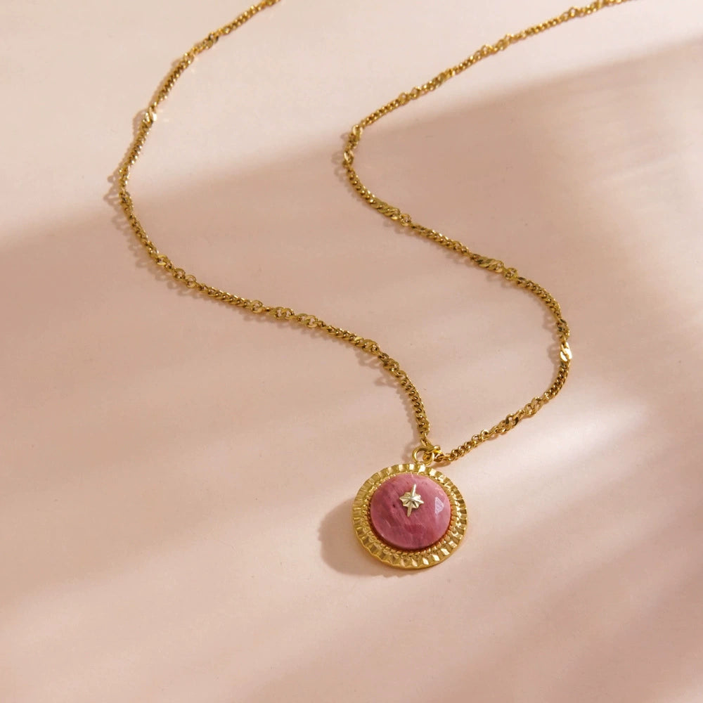 Rhodochrosite necklace elegantly displayed on a jewelry stand, highlighting its luxury.