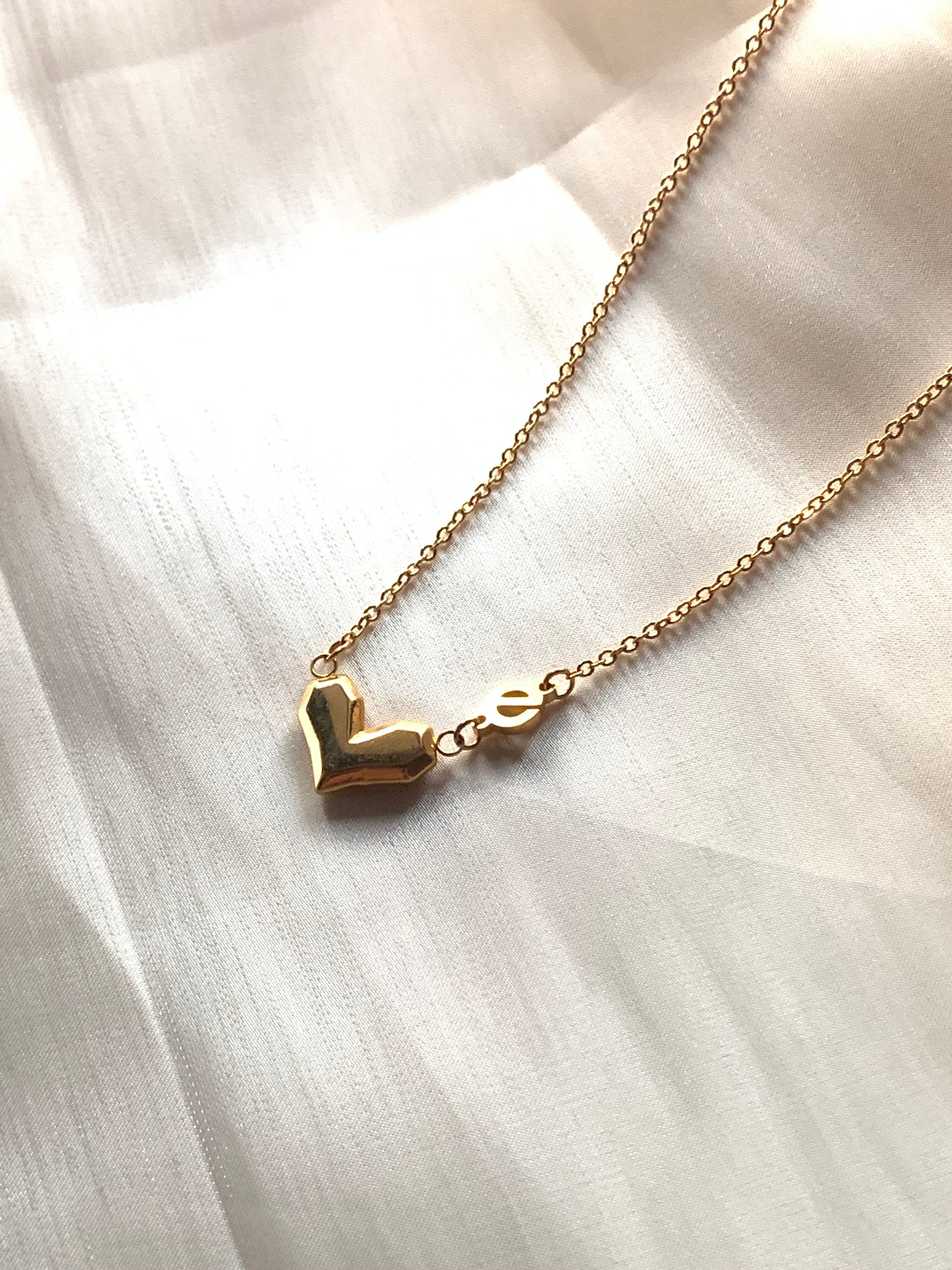 Close-up of the Love Power Heart Gold Necklace, symbolizing love and female empowerment.