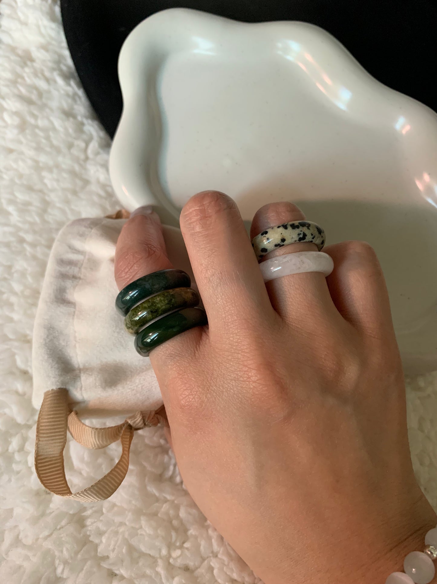 A fashionable display of stacked rings from the collection, showcasing a mix of textures and colors.