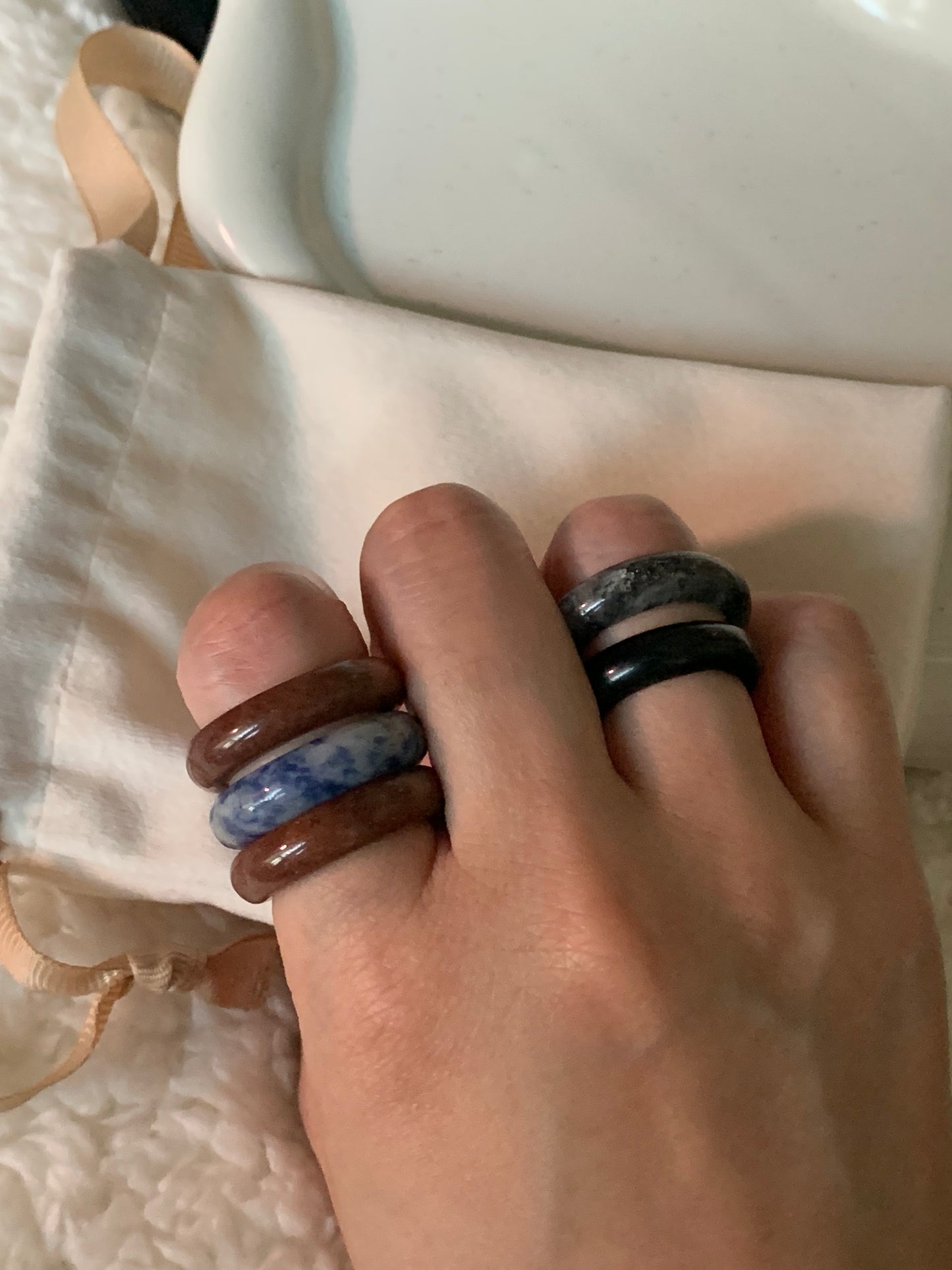 An elegant arrangement of multiple rings layered together, highlighting their unique designs and color combinations.