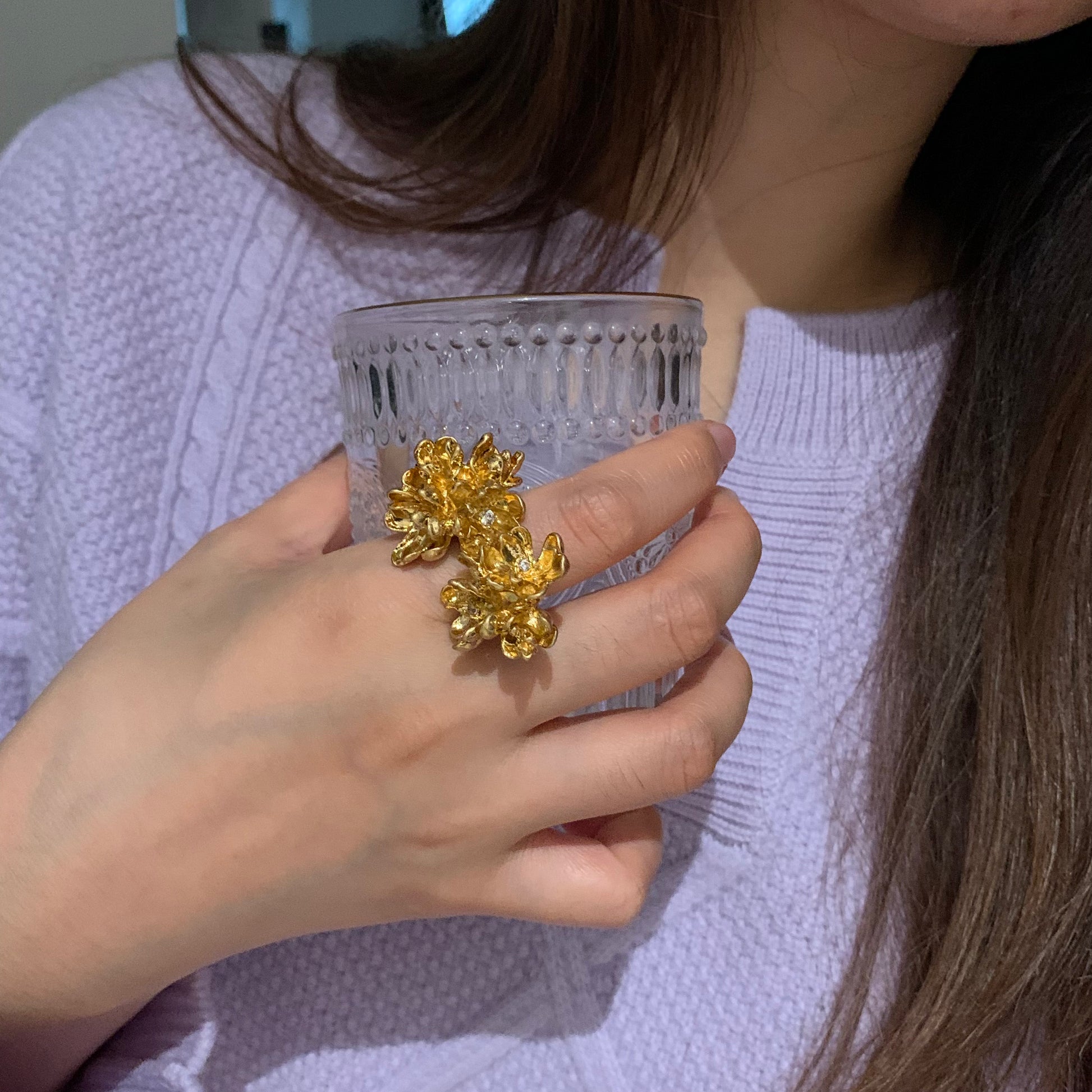 Lifestyle shot of a model wearing the twin blossom ring at an outdoor event